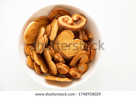 palmier cookie showing inside a bowl in white background
