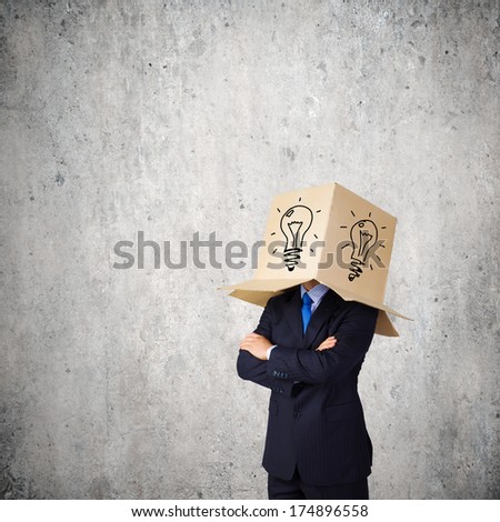 Businessman with box on head and idea symbol