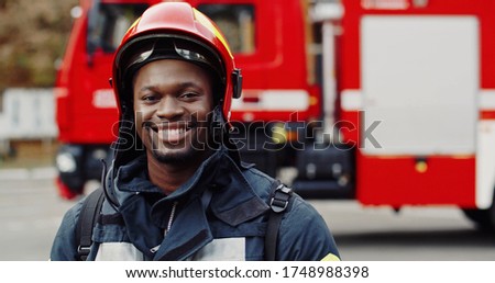 Portrait of african american Firefighter in protective suit. Firefighter portrait on duty. 
