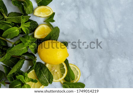 Summer background composition with lemon slices, leaves and mint. Minimal lemonade drink concept. Top view