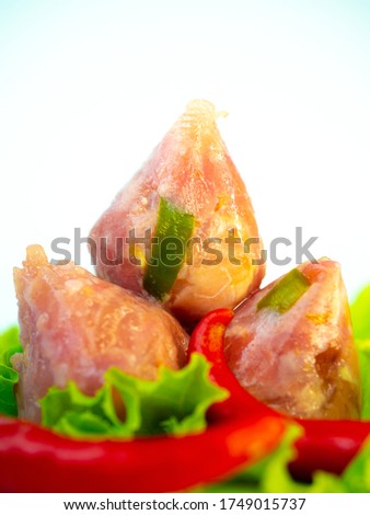 Fermented pork sausage or sour pork is food in northern of Thailand It has a sour taste Made for food preservation. this picture on white background
