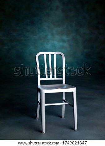 Steel Chair on Green Studio Textured Background. Classic or Industrial Style. Testimonial icon.
Copy Space for Text or Image.