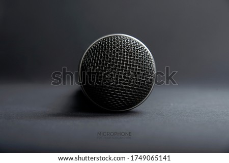 A Black microphone on dark shadow background for audio record or Podcast concept - music instrument concept
