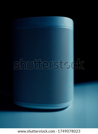 Abstract sound speaker grille on blue neon light.