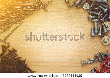 Screws, nails, bolts srt on the wooden table