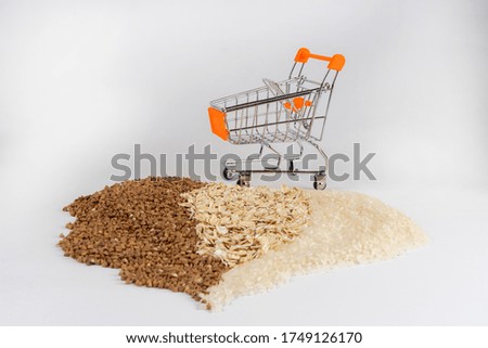 Field cereal rice oatmeal and buckwheat on a background with a supermarket cart