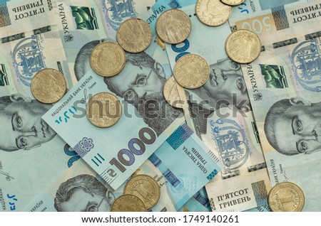 Background from Ukrainian money. A bill in a thousand hryvnia, five hundred hryvnia and a coin one hryvnia.