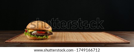 classic american burger on dark background large format picture