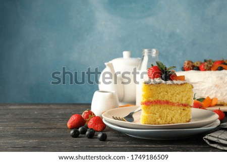 Composition with delicious berry cream cake on wooden table. Tasty dessert