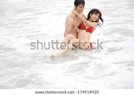 Japanese couple playing in water