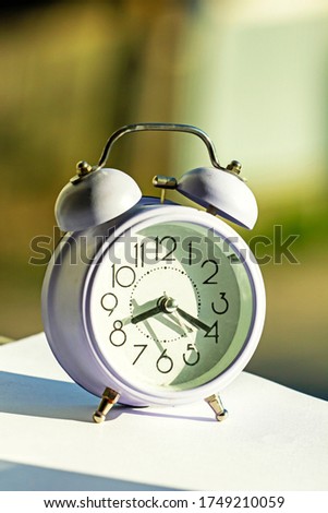alarm clock on the windowsill on a sunny morning