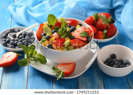 Summer Fruit salad with oranges, strawberries, blueberries, kiwi and fresh mint. Healthy food