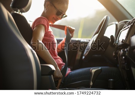 Female driver buckle up the seat belt before driving car Royalty-Free Stock Photo #1749224732