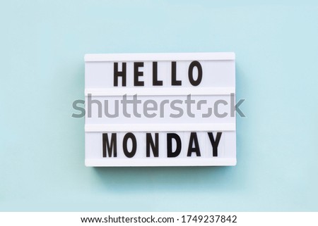 Text "hello monday" on lightbox for holiday - Thank God Its Monday. Start of working week concept. Top view on blue background.