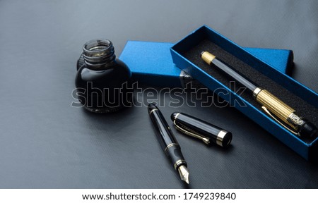 
Beautiful fountain pen. under exposed photo on a black background.