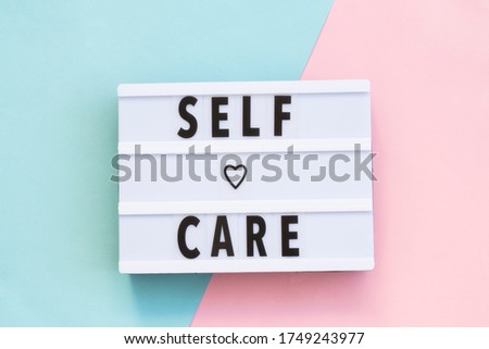 Self-care word on lightbox on color background flat lay. Take care of yourself