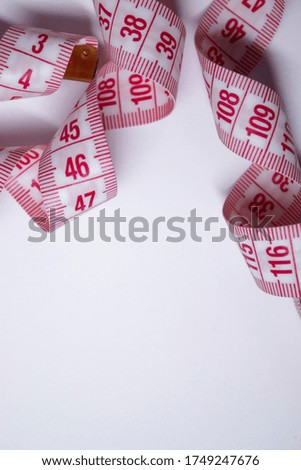 Red measuring tape on white background. Loss weight concept. Top view. Copy space. Isolated. . High quality photo