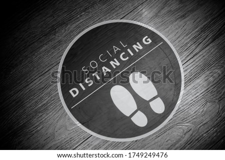 Footprint sign for stand in the mall.Social Distance word sticker poster.Social Distancing 6 Ft. Instruction against the Spread.New normal Reopen Mall.Social distancing in the workplace during covid19