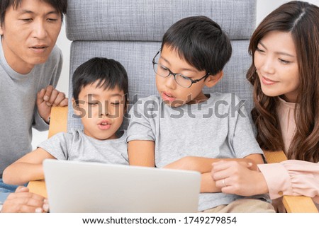 Asian family looking at laptop computer