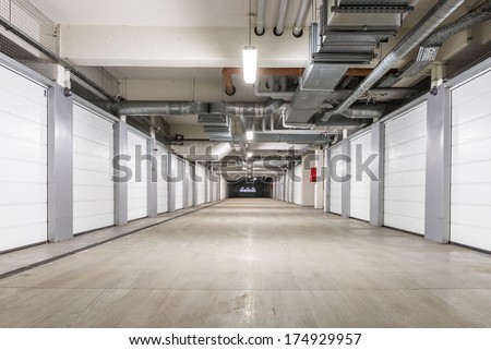 Underground European storage and parking facility with numbered bays. Royalty-Free Stock Photo #174929957