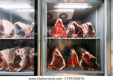Dry-aged Wagyu beef steak with large fillet in the fridge. The preparation process by let the beef break down by natural enzymes, creates a greater concentration of beef flavor, taste and more tender. Royalty-Free Stock Photo #1749308876