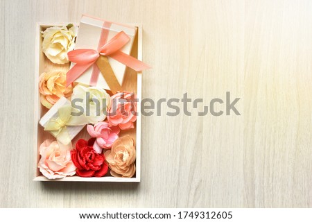 gift boxes and flowers on white wooden background.copy space for text