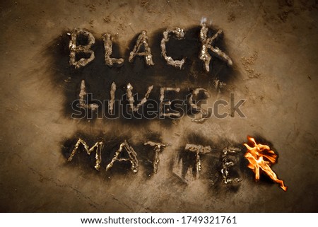 Black Lives Matter text slogan fire flames, human rights protest message revealed by black powdered soot from flaming letters, black lives matter worldwide movement, end racism concept