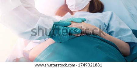 Doctor is a hero concept, during coronavirus COVID-19. the doctor fights the Coronavirus epidemic That is spreading worldwide. The doctor held the patient's hand to comfort save him in the hospital.  Royalty-Free Stock Photo #1749321881