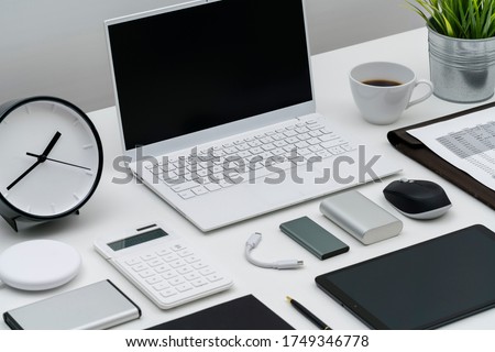 Flat lay of office desktop and gadgets at an angle Royalty-Free Stock Photo #1749346778
