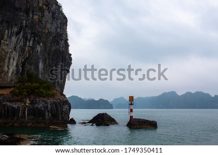 Signal beacon around limestine rocks in Ha Long bay, Vietnam, UNESCO World heritage, copy space for text, 