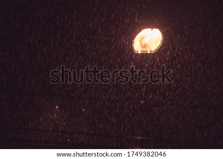 Blurred lamp light on rainning on night background