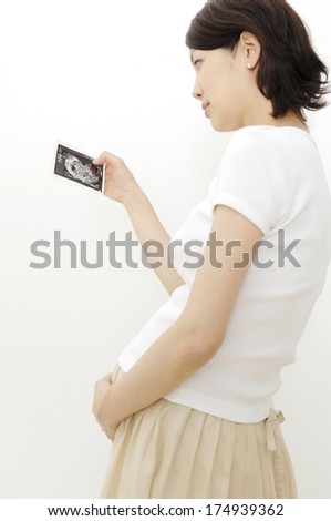 Pregnant Japanese Woman looking at the picture