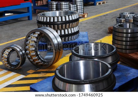 Production of bearings of different diameters. Heavy industry concept. Photos at the factory. Signal lines on the floor of the plant.