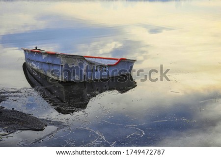 An old abandoned boat on the lake