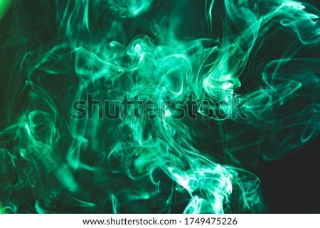 Green abstract shaped smoke against black background. Abstract background