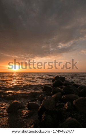 romantic sunset at sea with breakwater