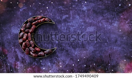 Dates in a moon shaped plate Islamic Iftar and Eid Al Adha concept background, colorful dates image decorated with  shape of crescent moon 