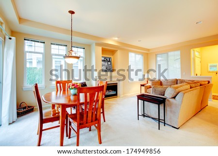 Bright living room with comfortable couch and fireplace including dining area