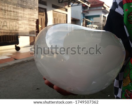 air bubbles filled with smoke. blimp in the hand of a small child
