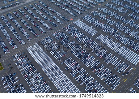 Cars export terminal in export and import business and logistics. Shipping cargo to harbor. Water transport International. Aerial view and top view. Royalty-Free Stock Photo #1749514823