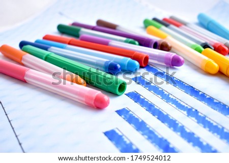 colorful crayons on diagram paper