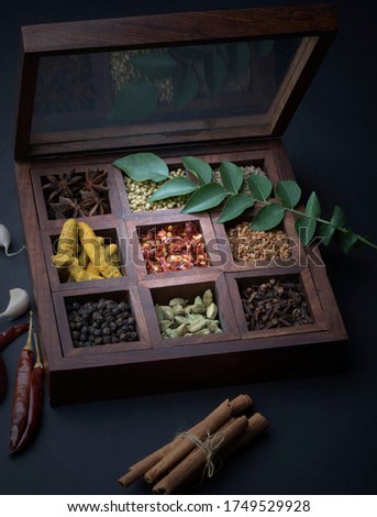 Different types of spices in wooden box Royalty-Free Stock Photo #1749529928