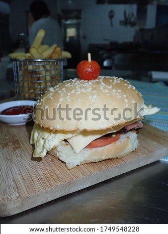 Freshly made burger with fries in Papua New Guinea . Food in PNG 