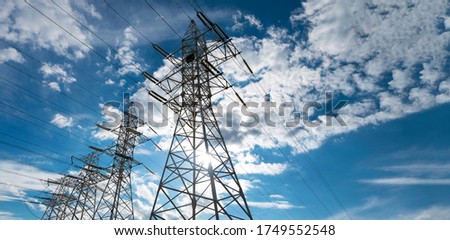 Panorama high voltage tower with power lines. Bottom view of high voltage pole power transmission tower. Green energy, environmental conservation concept. Royalty-Free Stock Photo #1749552548