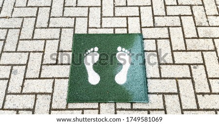 View of footprint sign for stand on the floor. Social distancing with COVID-19 coronavirus.green footprint sign.New normal ,Social distance.