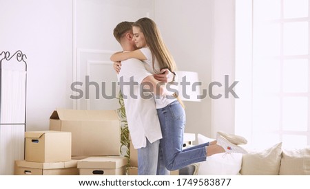 Lovely couple dancing in new empty flat