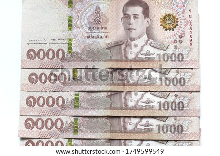 Close​ up​ many​ Thai currency​ 1,000 Baht.Banknote of Thailand isolated​ on​ white​ background​. Royalty-Free Stock Photo #1749599549