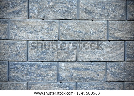 stone background texture of a gray wall imitating brick closeup