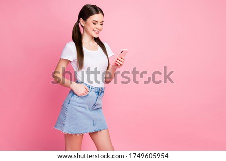 Portrait of her she nice-looking attractive lovely charming cheerful focused straight-haired girl using cell modern technology isolated over pink pastel color background