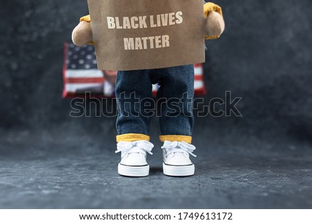 feet in sneakers on a dark background with the text Black Lives Matter. the concept of protests in the United States.